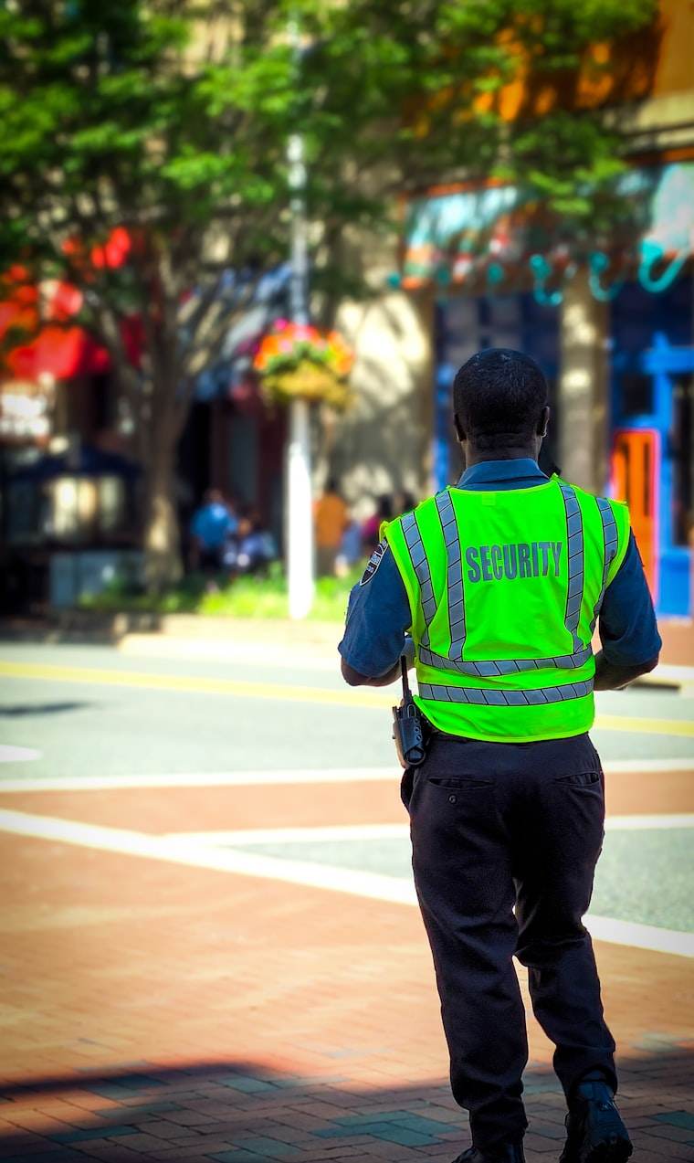 A uniformed security officer on a street